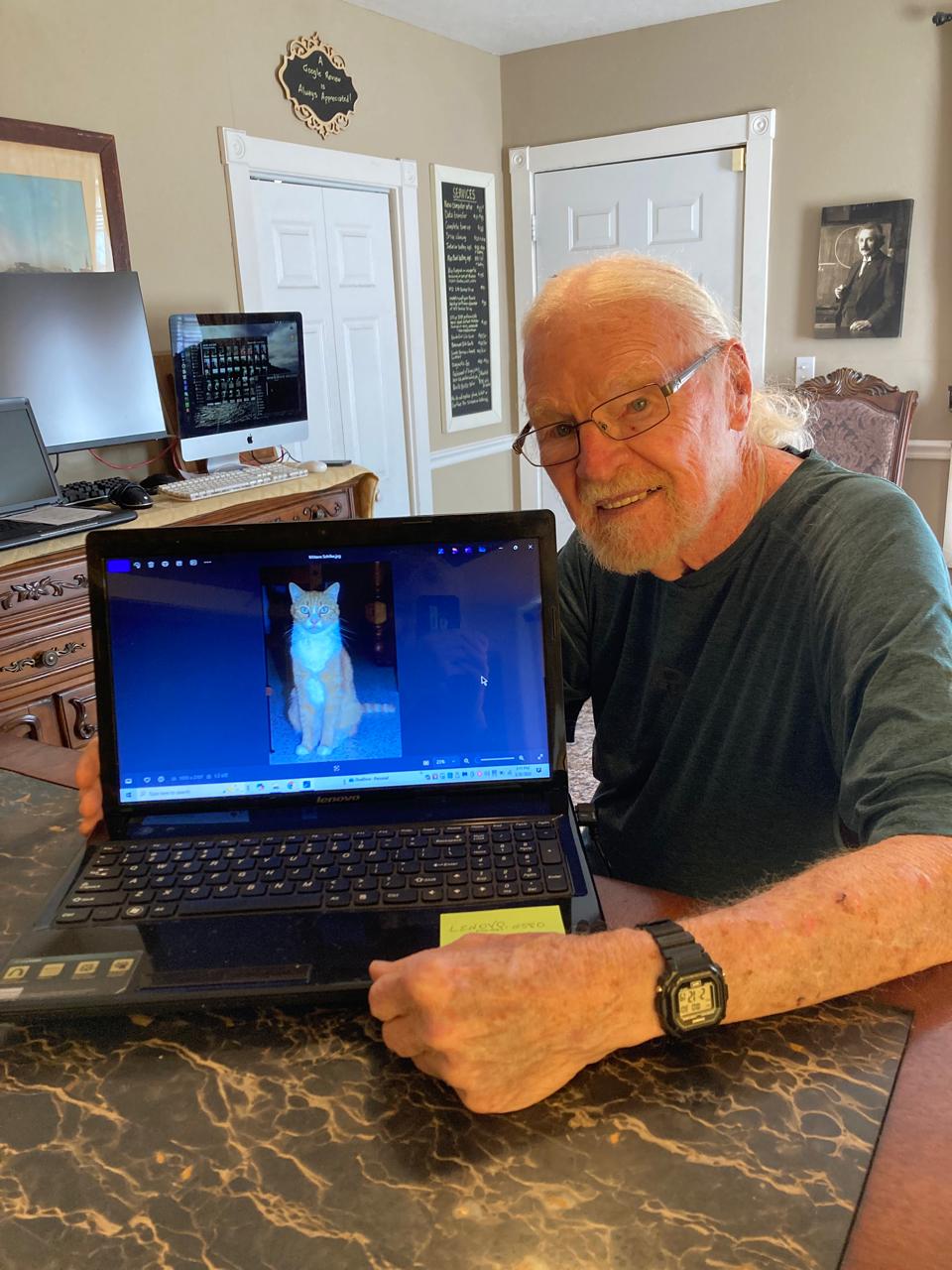 A person displaying a laptop at the shop